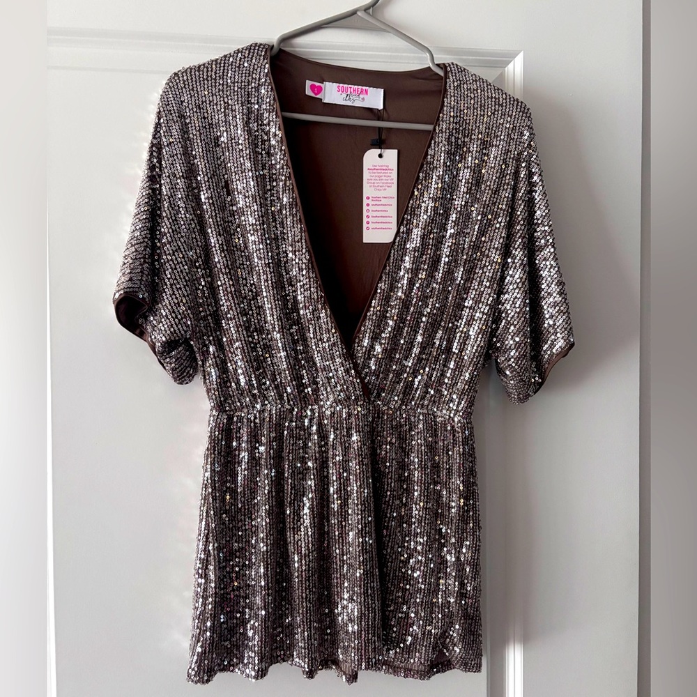 Sequin short sleeve top.  Flows at the arms, gathered waist and flows at bottom